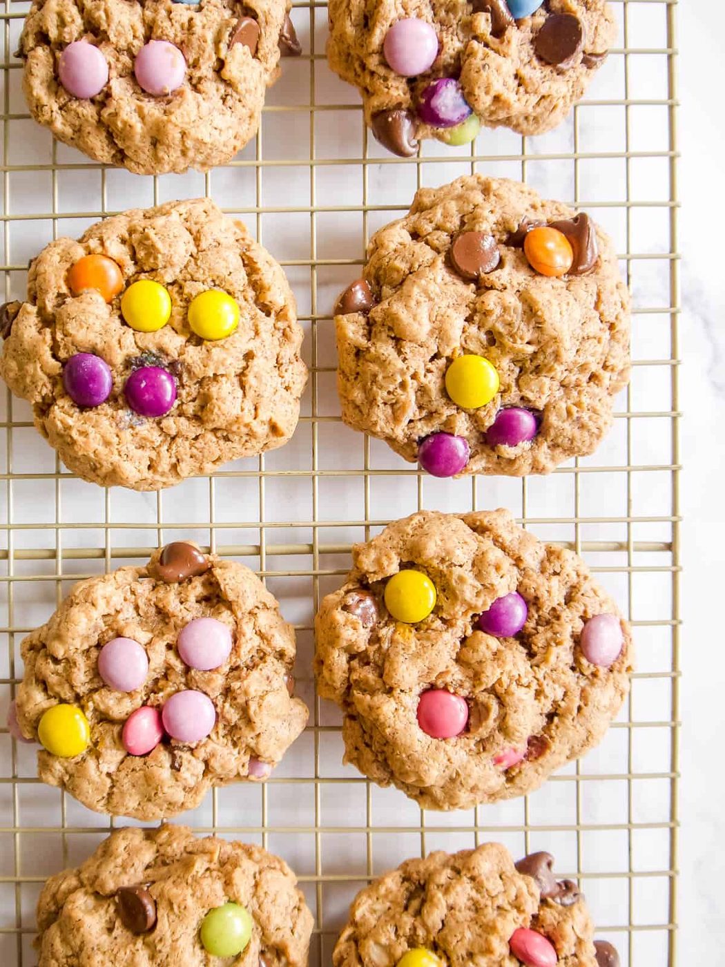 Gluten free monster cookies on a cooling rack.