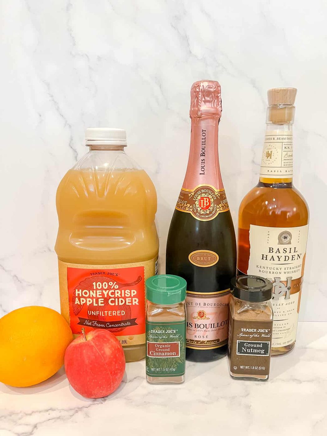 Ingredients needed to make spiked a apple cider cocktail.