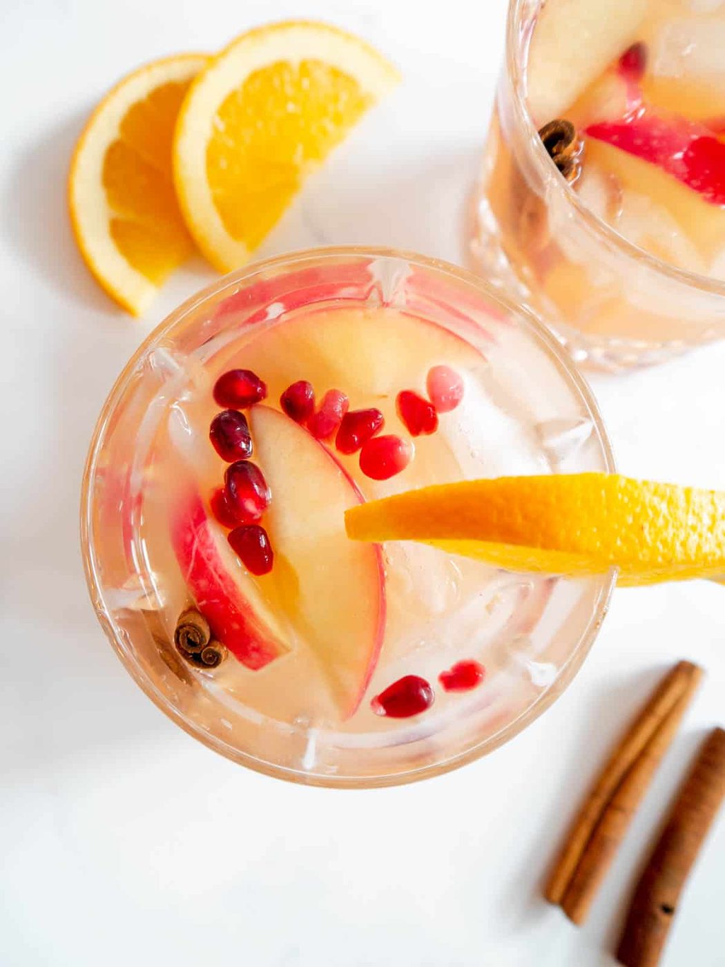 Apple Cider Whiskey Cocktail with pomegranate seeds added to the cups.
