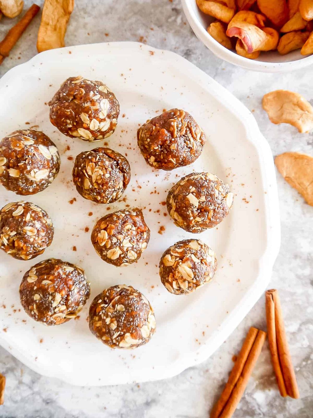 Apple pie energy balls on plate with cinnamon.