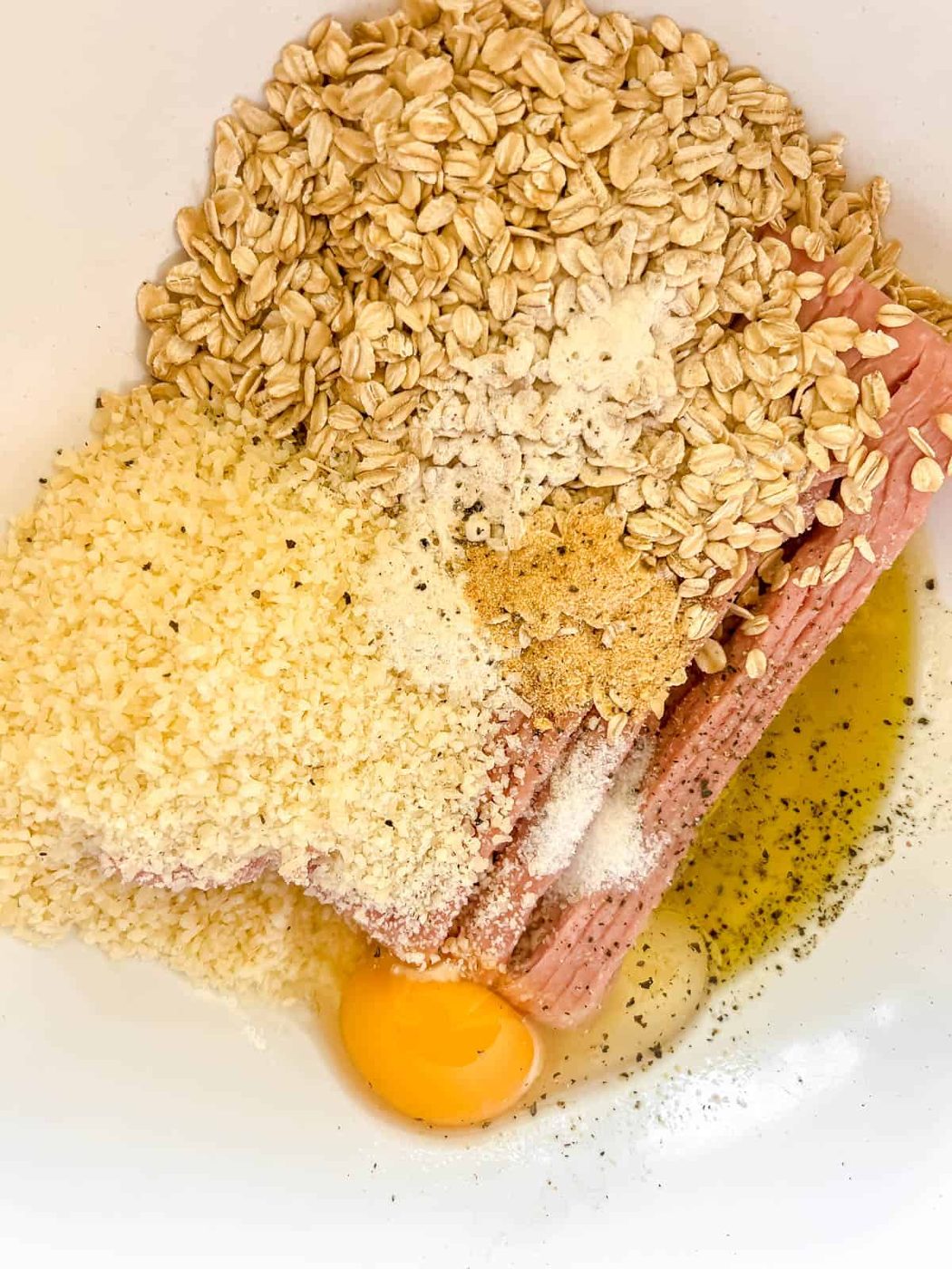 All the ingredients to make gluten-free meatballs in a bowl.