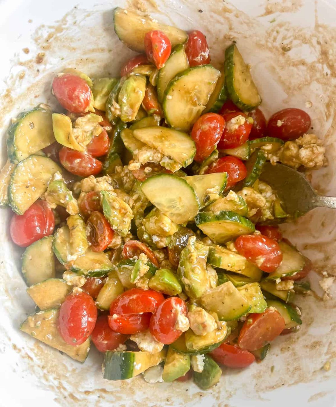 Cucumber tomato and avocado salad mixed together.