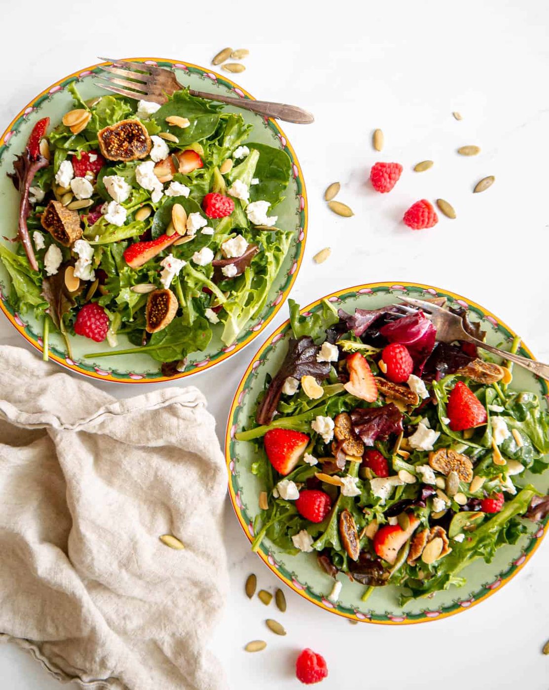 Strawberry goat cheese salad in two plates.