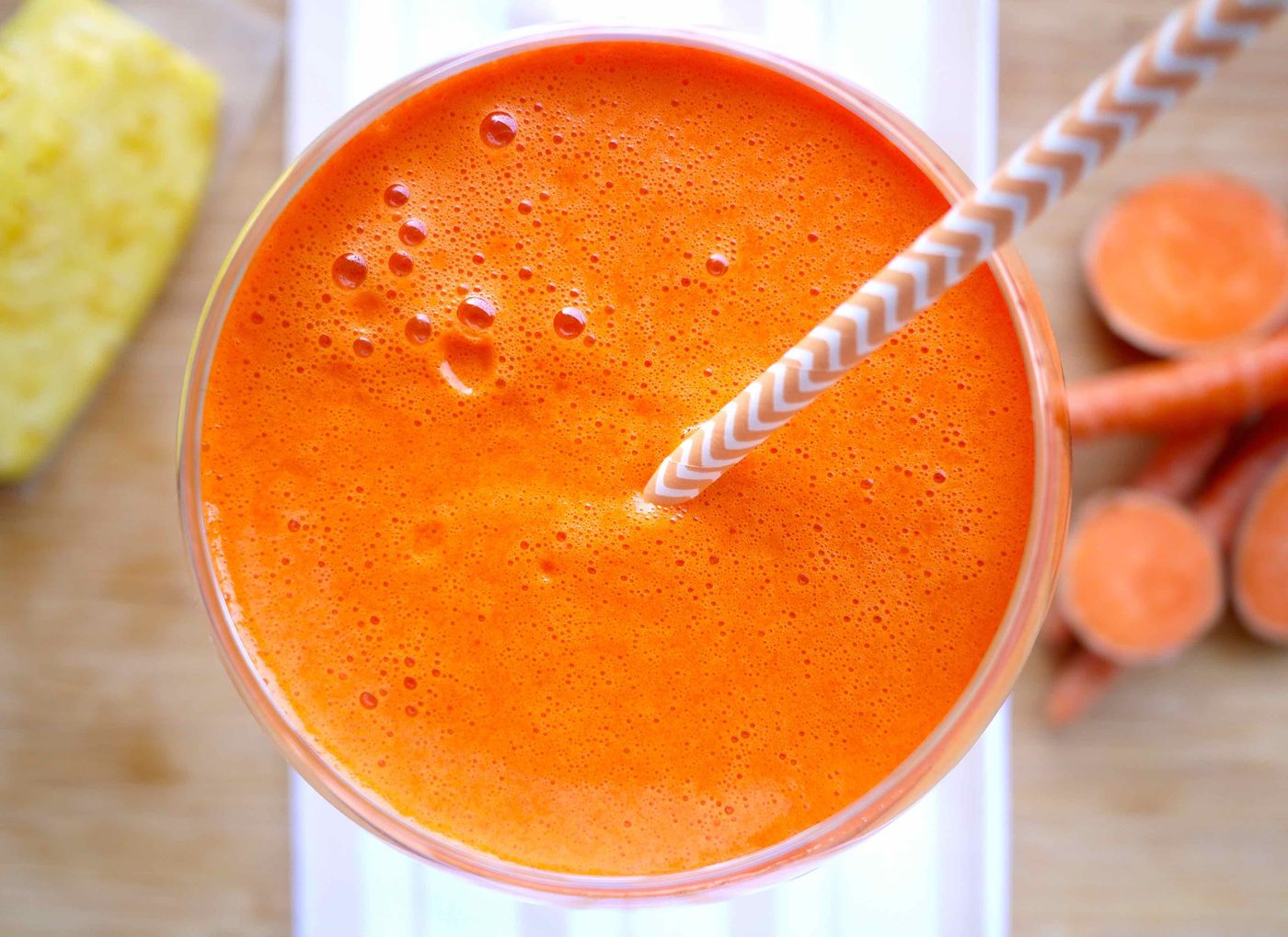 Sweet potato, mango, carrot, pineapple juice in a glass.