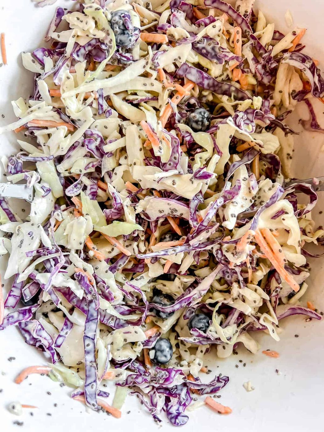 Coleslaw with fruit mixed together.