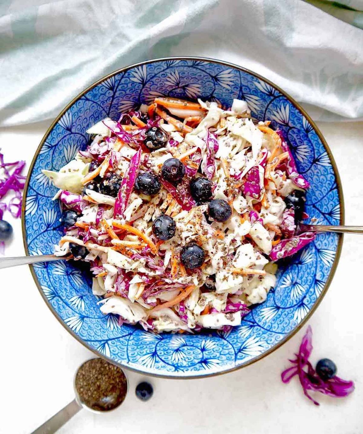 Lighter coleslaw with blueberries and chia seeds mixed in.