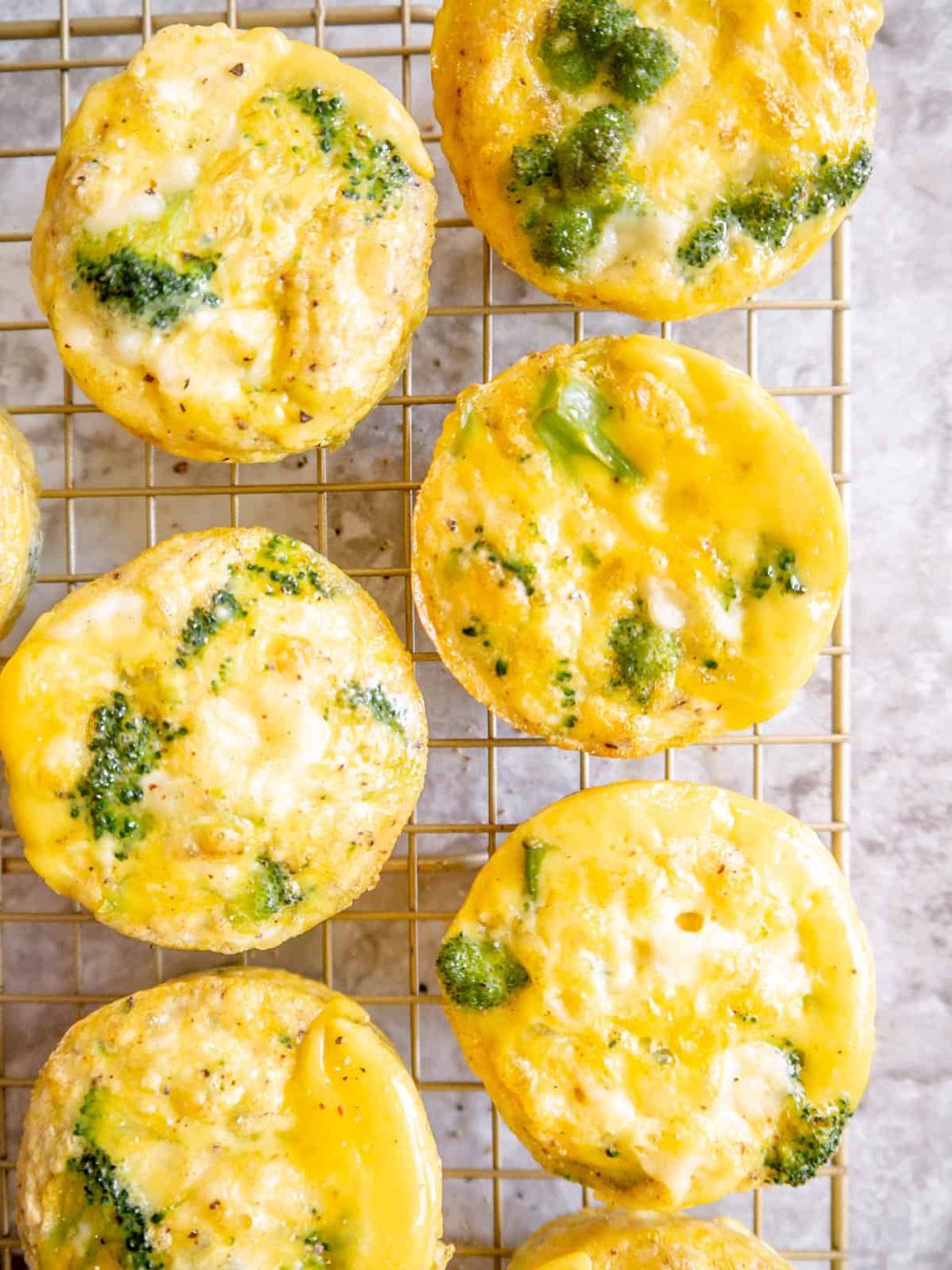 Broccoli cheddar Keto egg bites cooling on a drying rack.