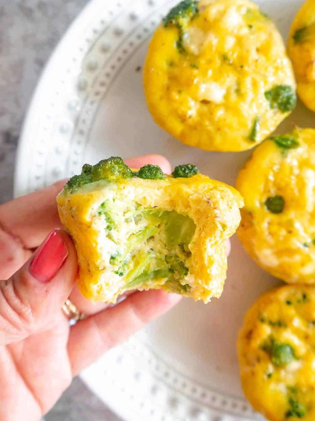 A bite taken out of a broccoli cheddar egg bite.