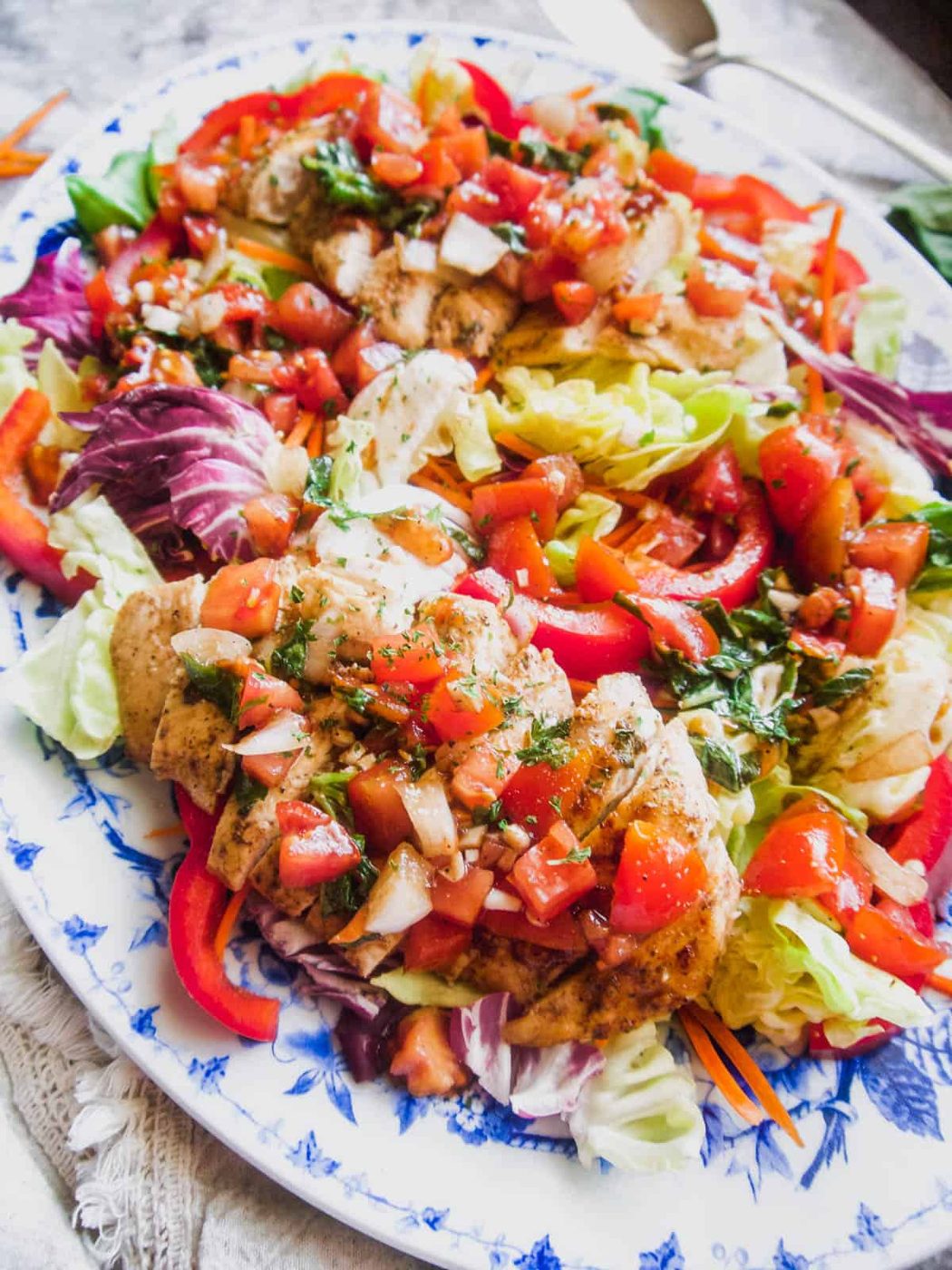 Bruschetta salad with grilled chicken on top.