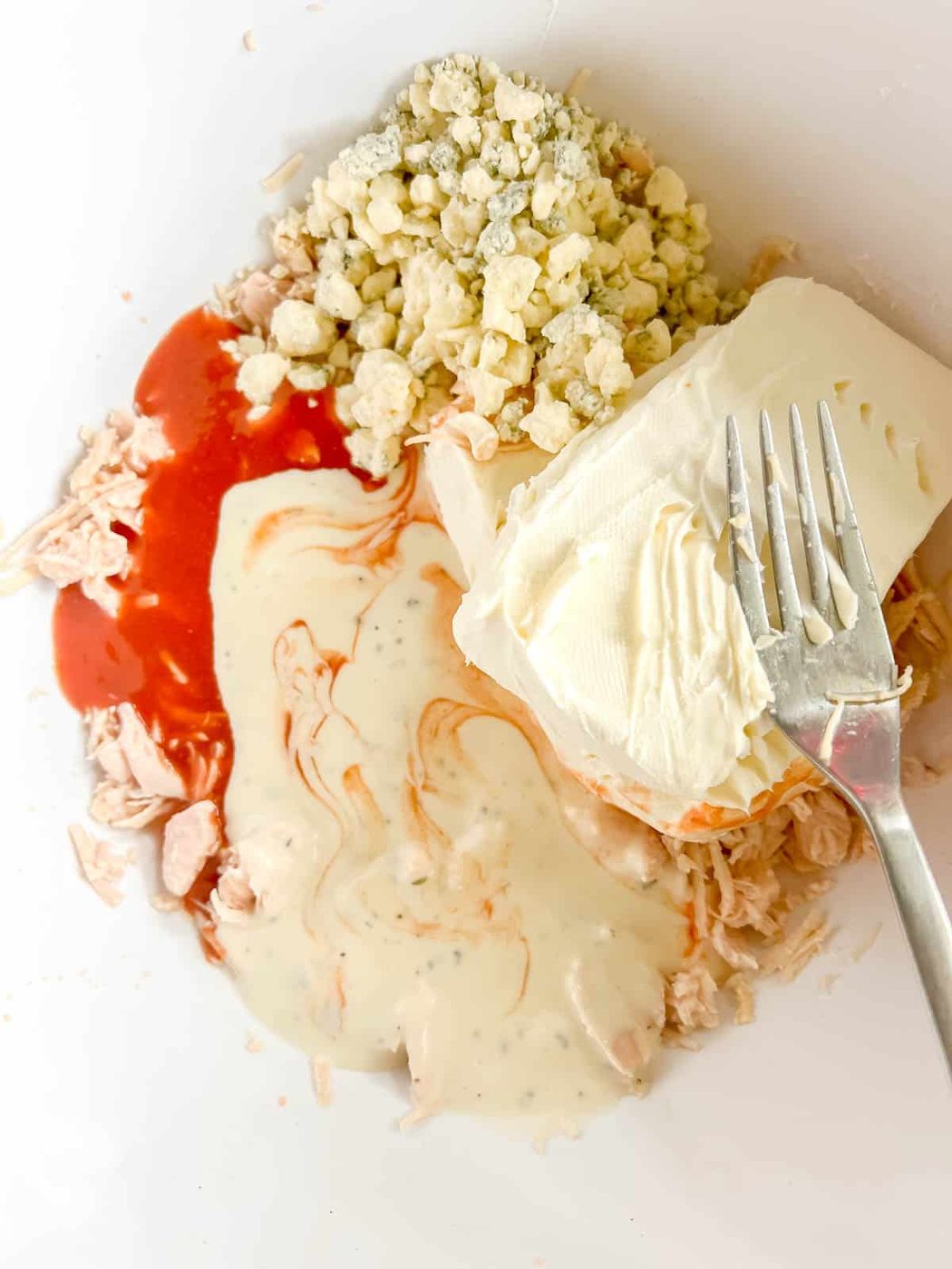 All the other buffalo chicken ingredients added to the bowl.
