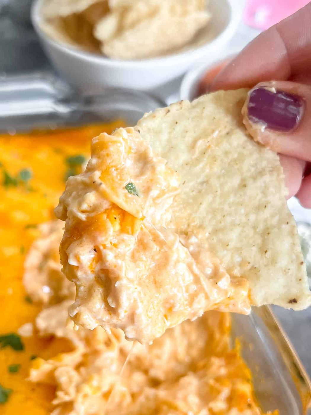 A chip dunked into keto buffalo chicken dip.