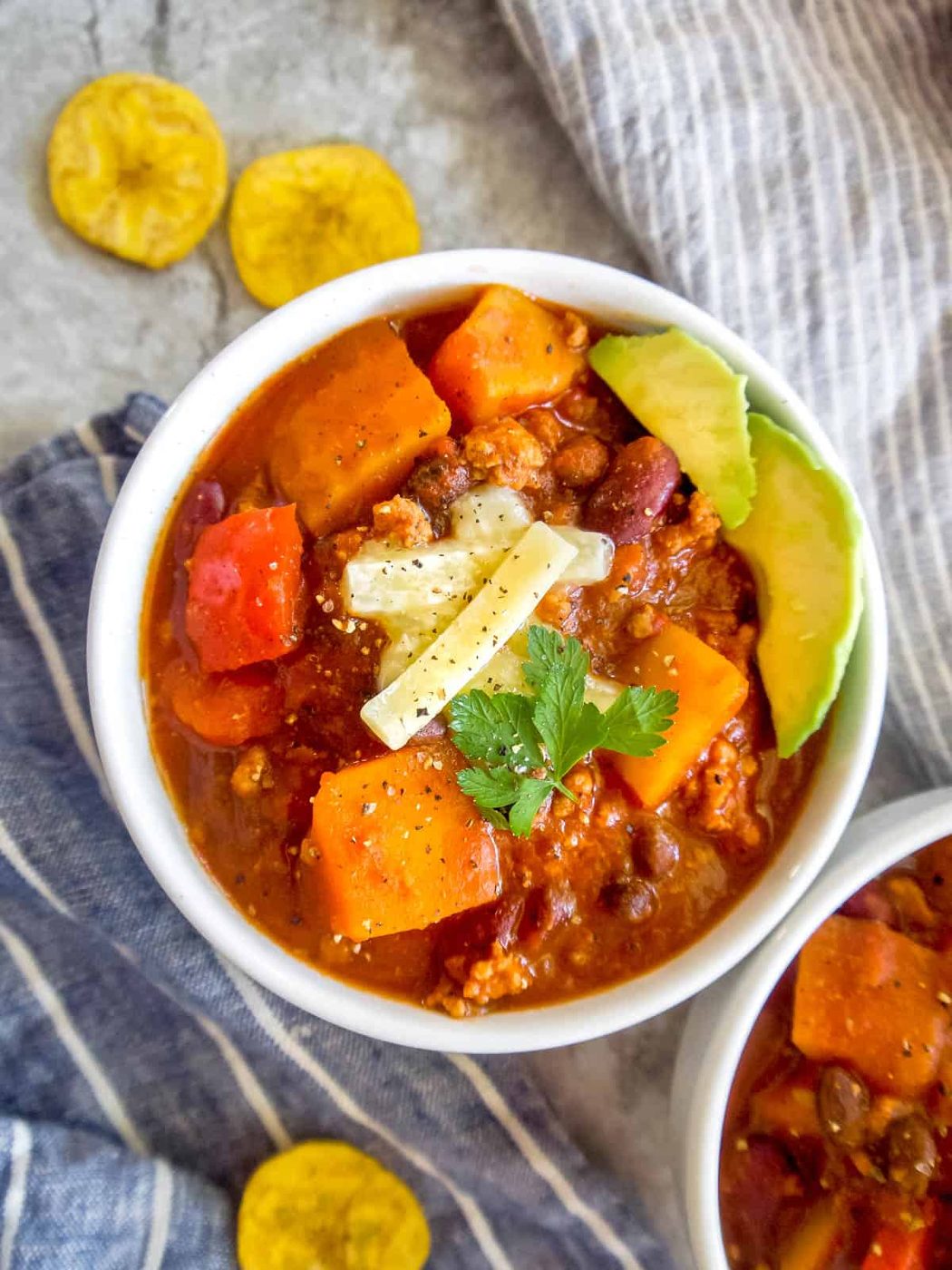 Butternut squash chili with ground turkey in two bowls.