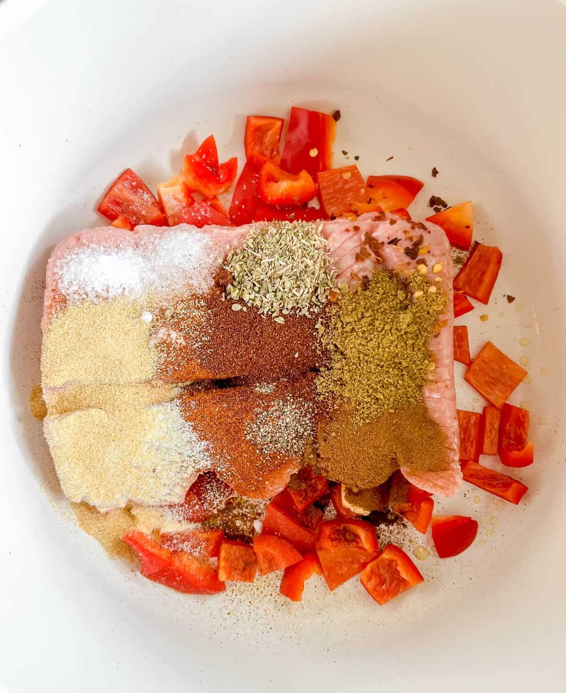 Ground turkey and spices added to the pan.