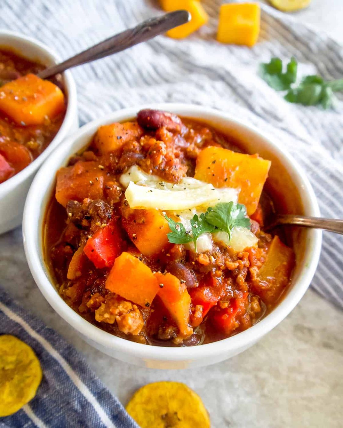 Turkey black bean butternut squash chili in a bowl with a spoon.