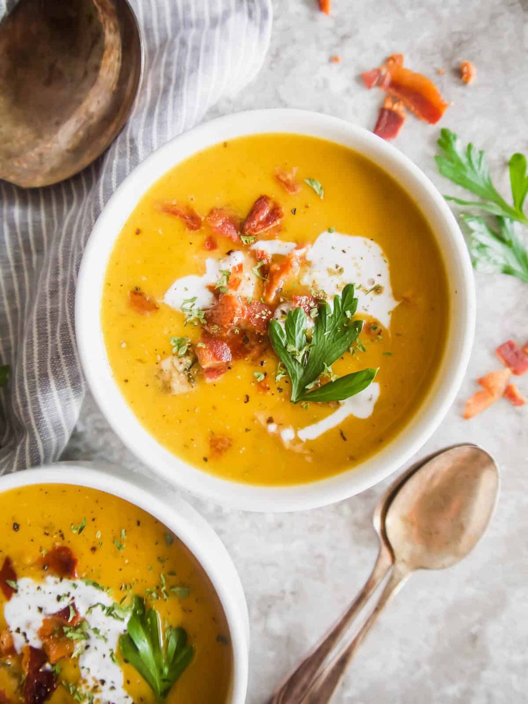 Aerial view of butternut squash soup with chicken in bowls.