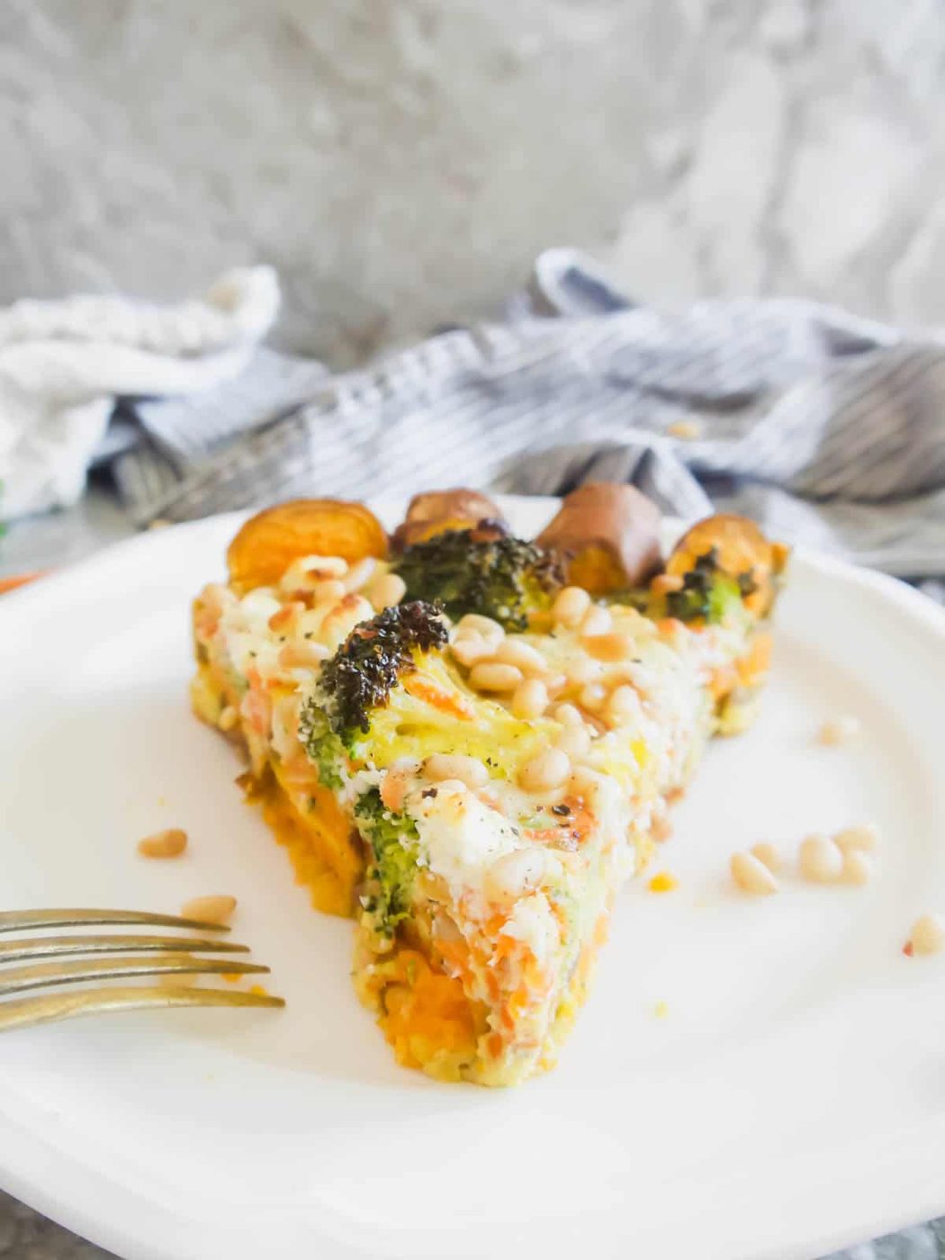 A slice of carrot quiche on a plate.