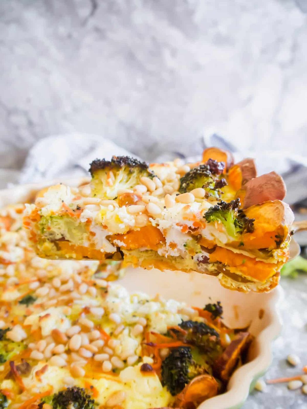 A slice of quiche with sweet potato crust.