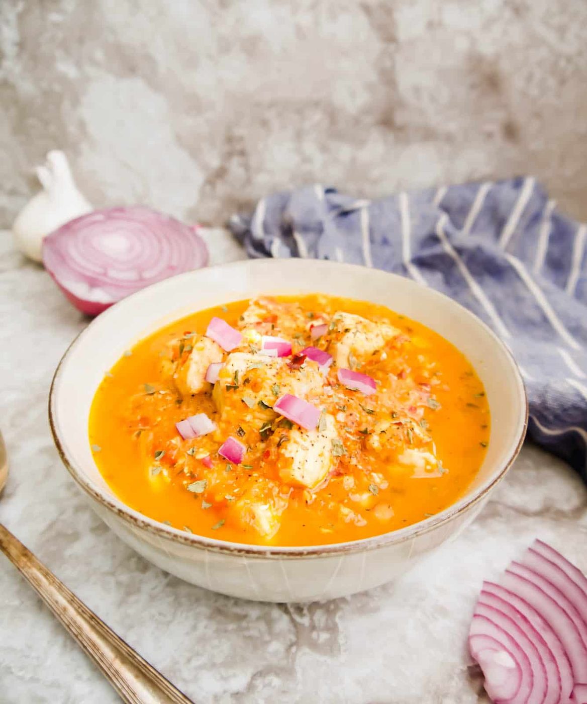 Cherry tomato sauce with chicken in it in a bowl.
