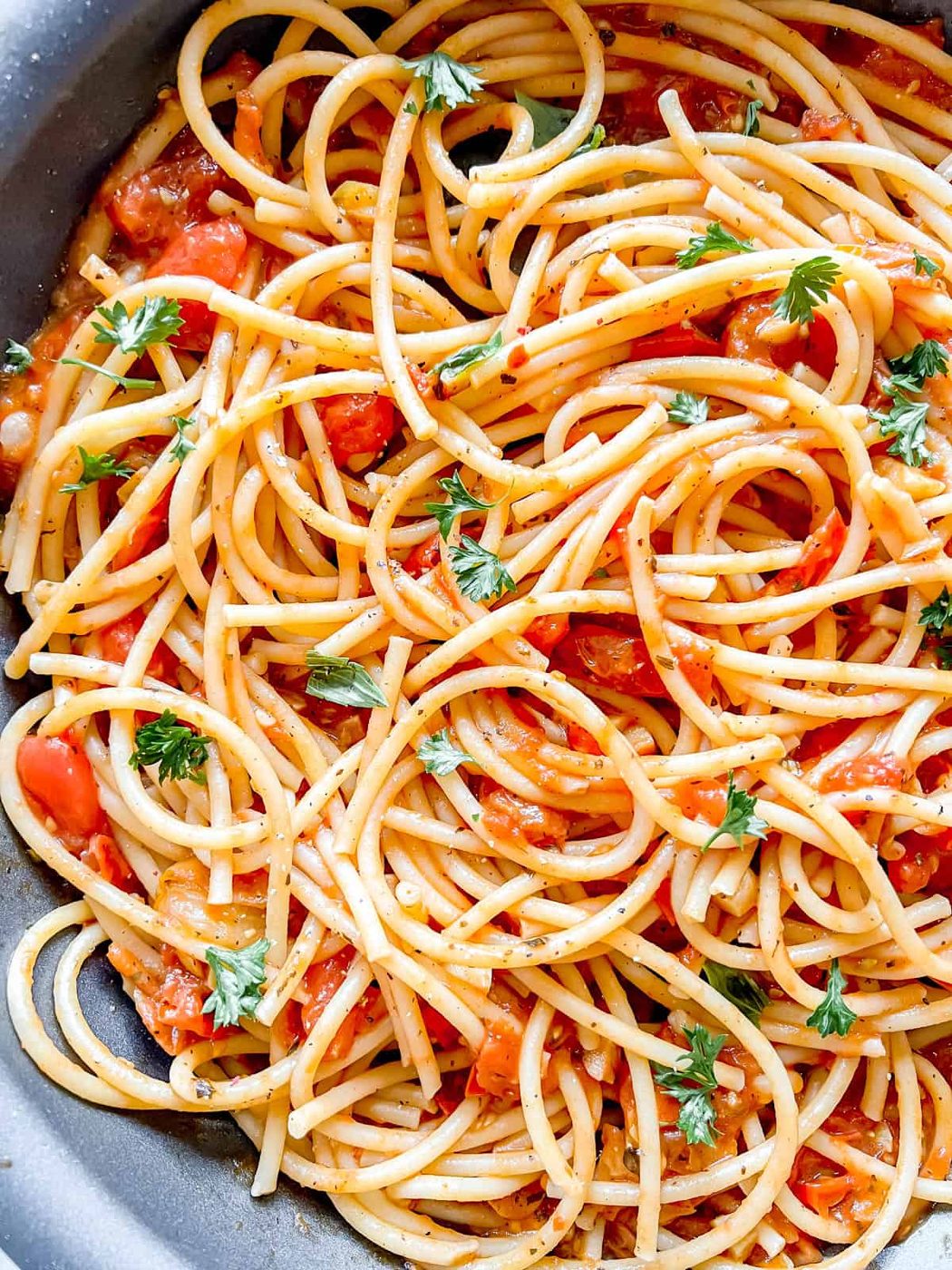 Pasta mixed into the cherry tomato sauce.