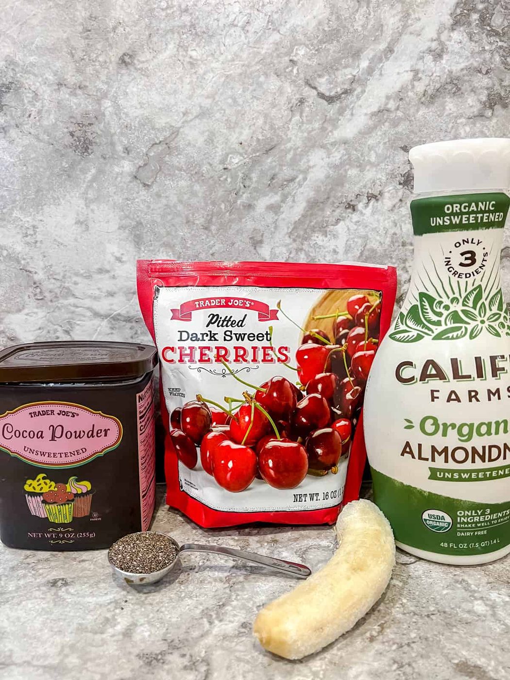 Ingredients needed to make a cherry cocoa smoothie.