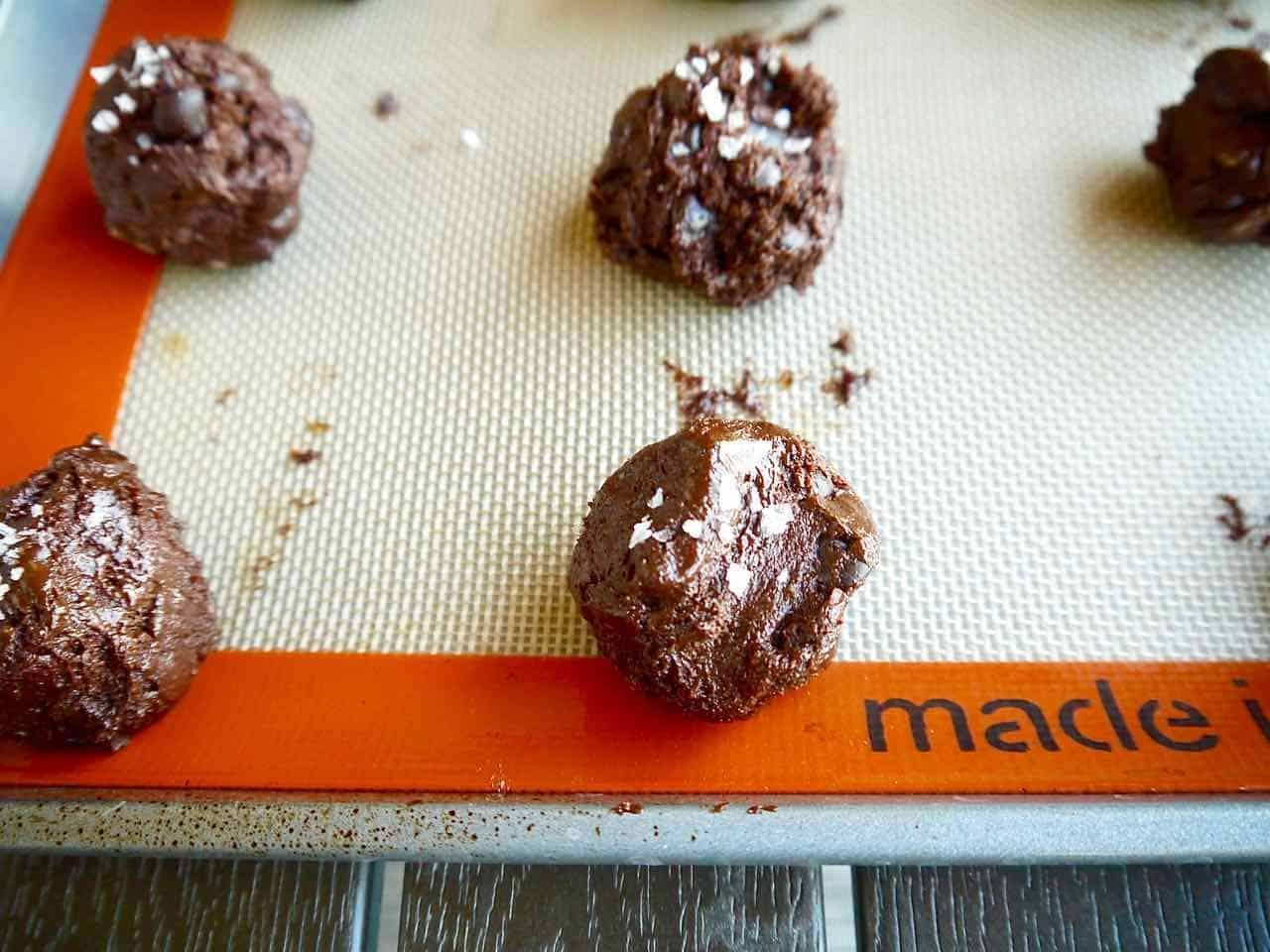 Cookie dough rolled in balls on pan.