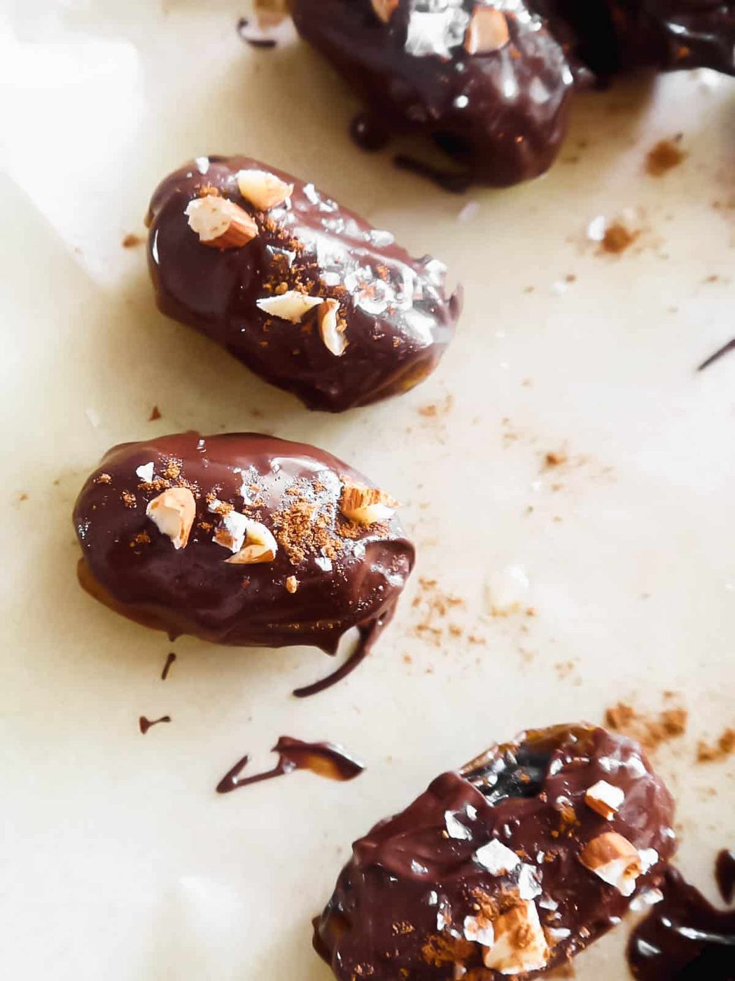 Chocolate covered dates with salt and almonds on top.