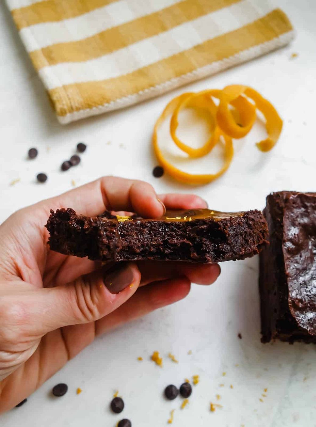 Bite taken out of a chocolate orange brownie.