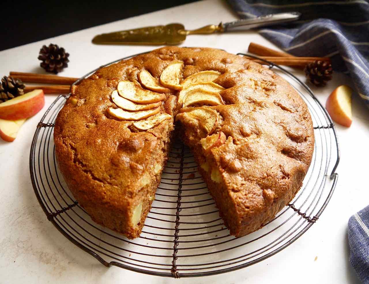 A slice taken out of a gluten-free apple cake.