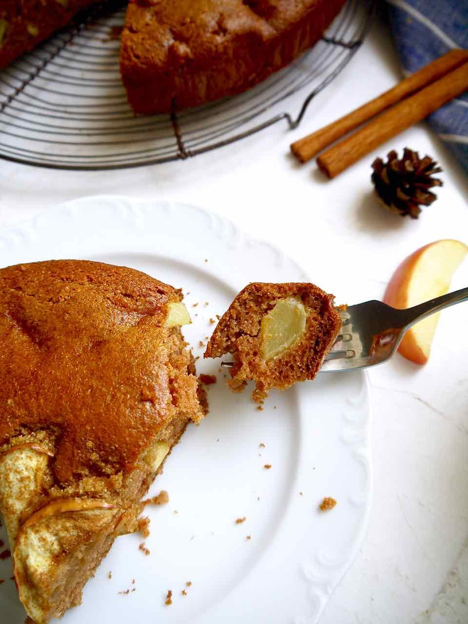 A bite of lighter apple cake on a plate.
