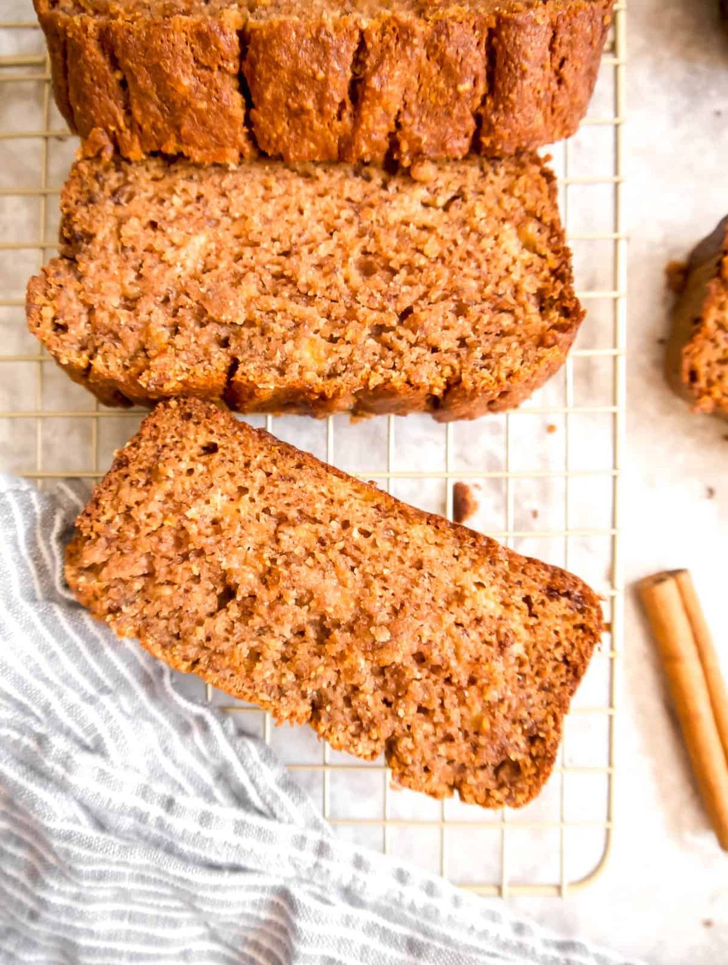 Banana bread with almond flour slices on a drying rack.