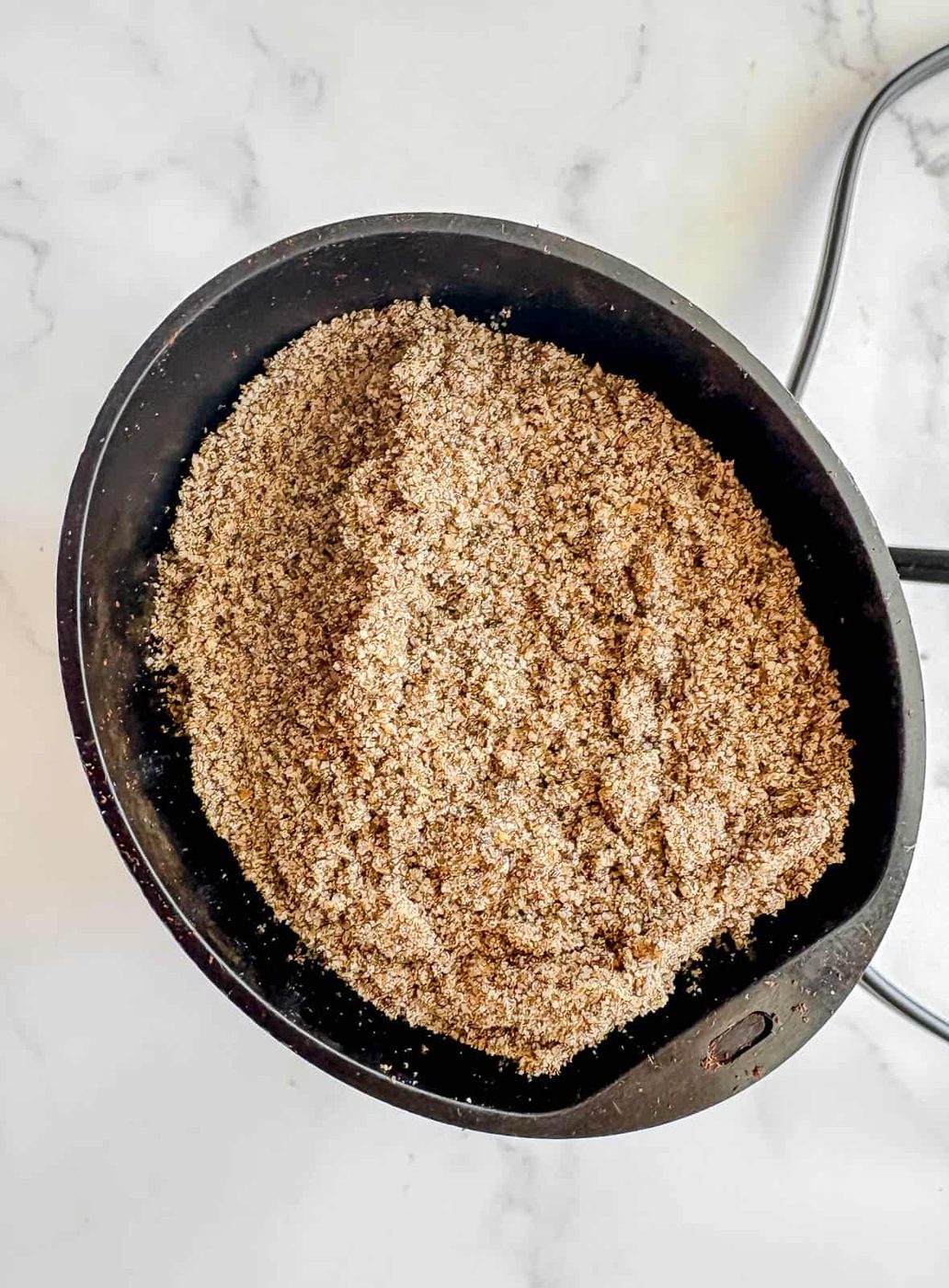 Grinding chia seeds in a coffee grinder.