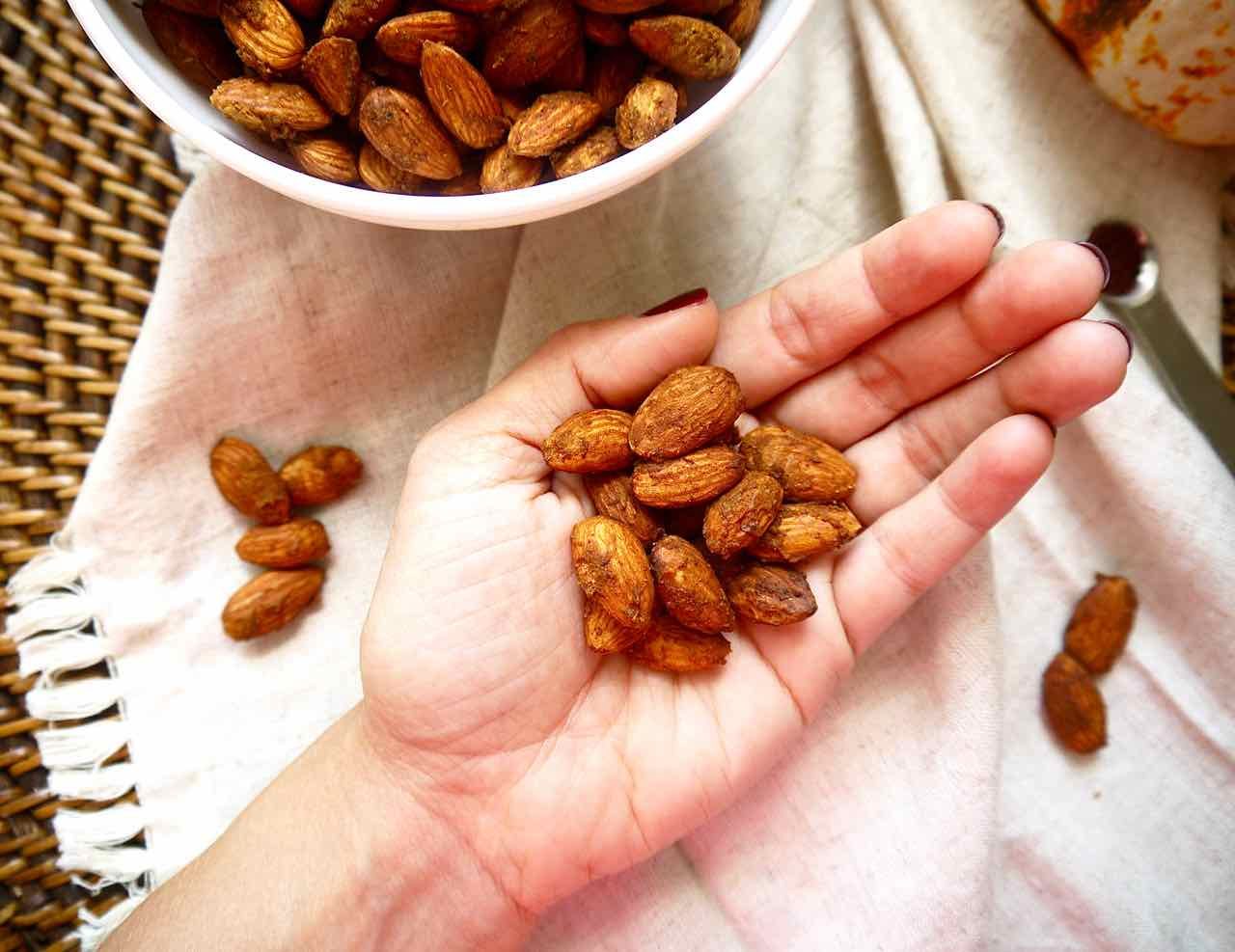 Pumpkin almonds in a hand.
