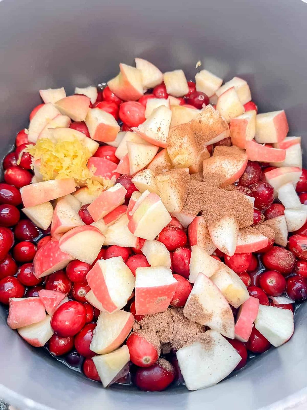 Cran-apple sauce ingredients in a pan.