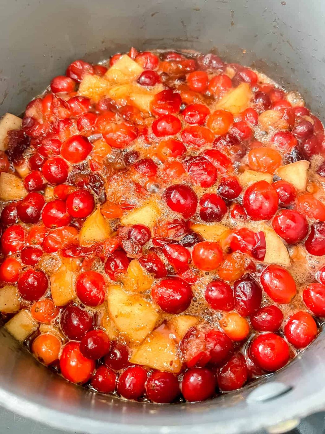 Cranberry sauce cooking in a pan.