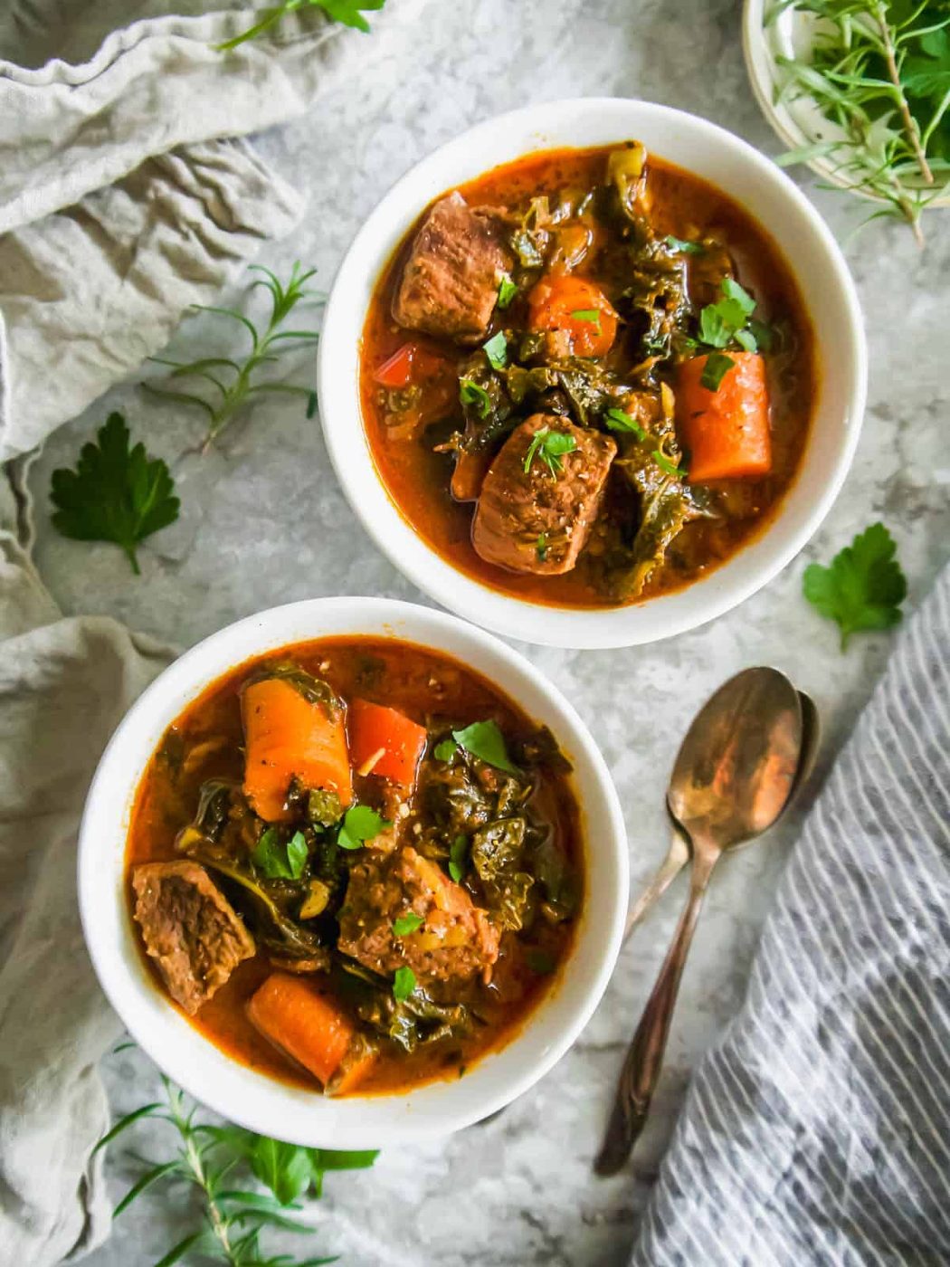 Aerial view of lighter beef stew in two bowls.