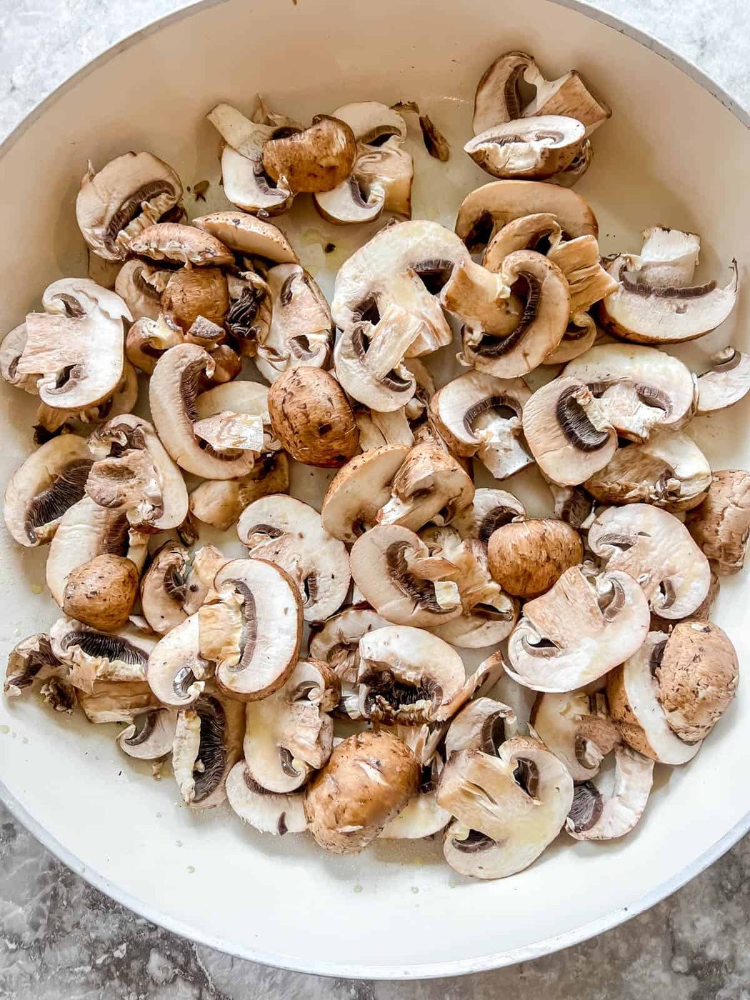 Mushrooms in a frying pan before cooking.