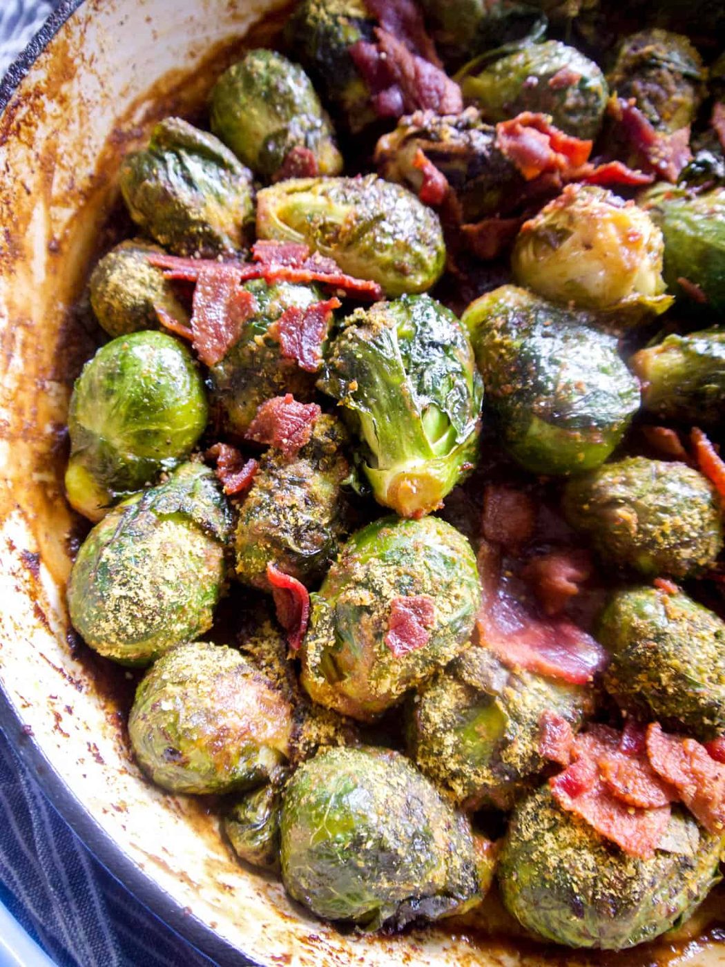 Whole30 brussel sprouts in a pan with bacon on top.