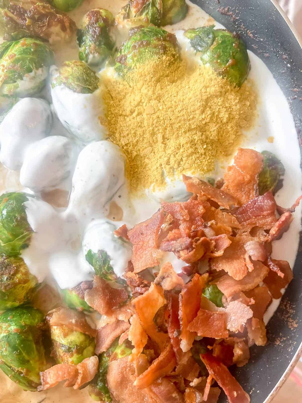 All the sauce ingredients added to the cooked brussels sprouts.