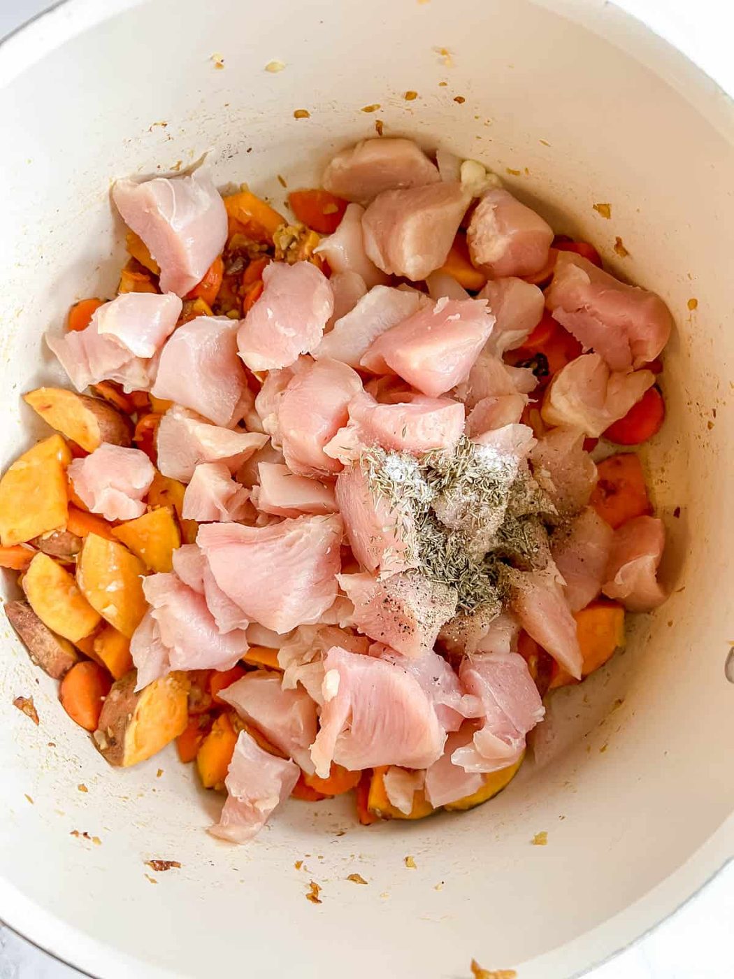 Diced chicken and spices added to the pan.