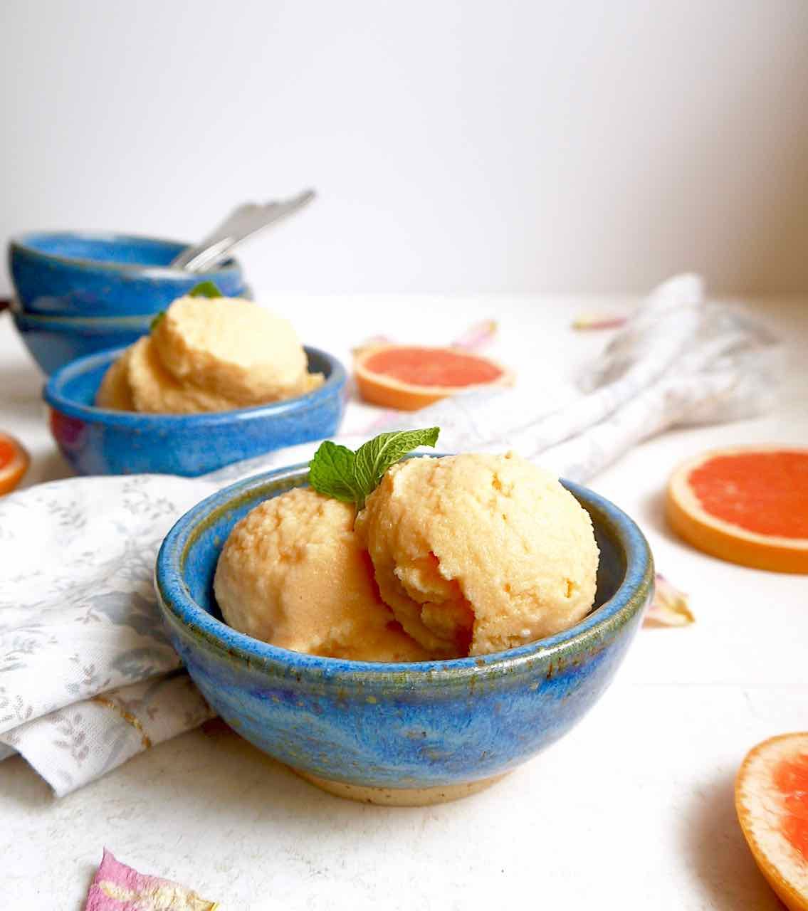 Pink grapefruit sorbet in a bowl.