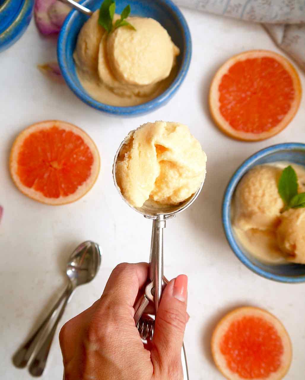Grapefruit sorbet in an ice-cream scoop.