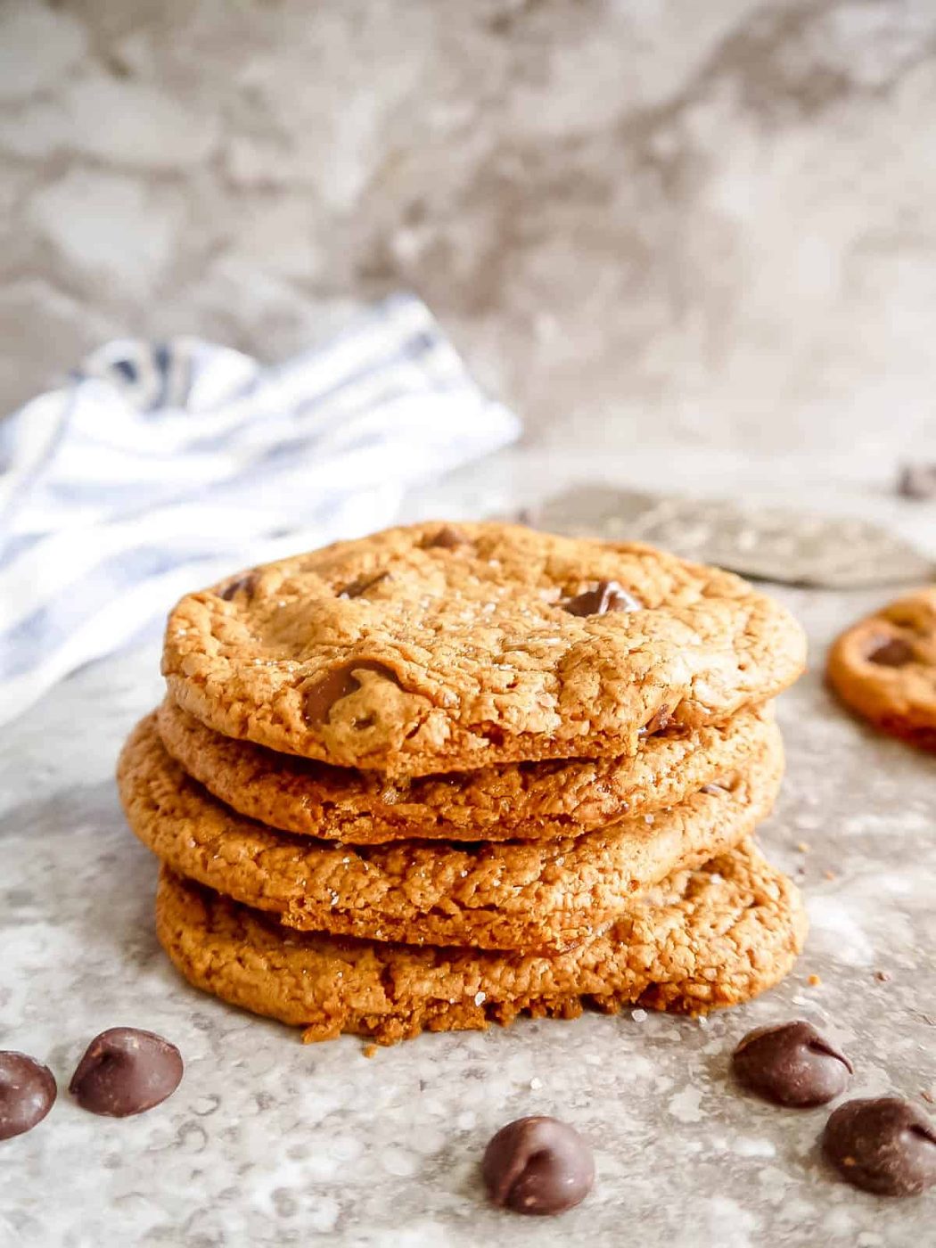 Crispy paleo chocolate chip cookies stacked on top of each other.