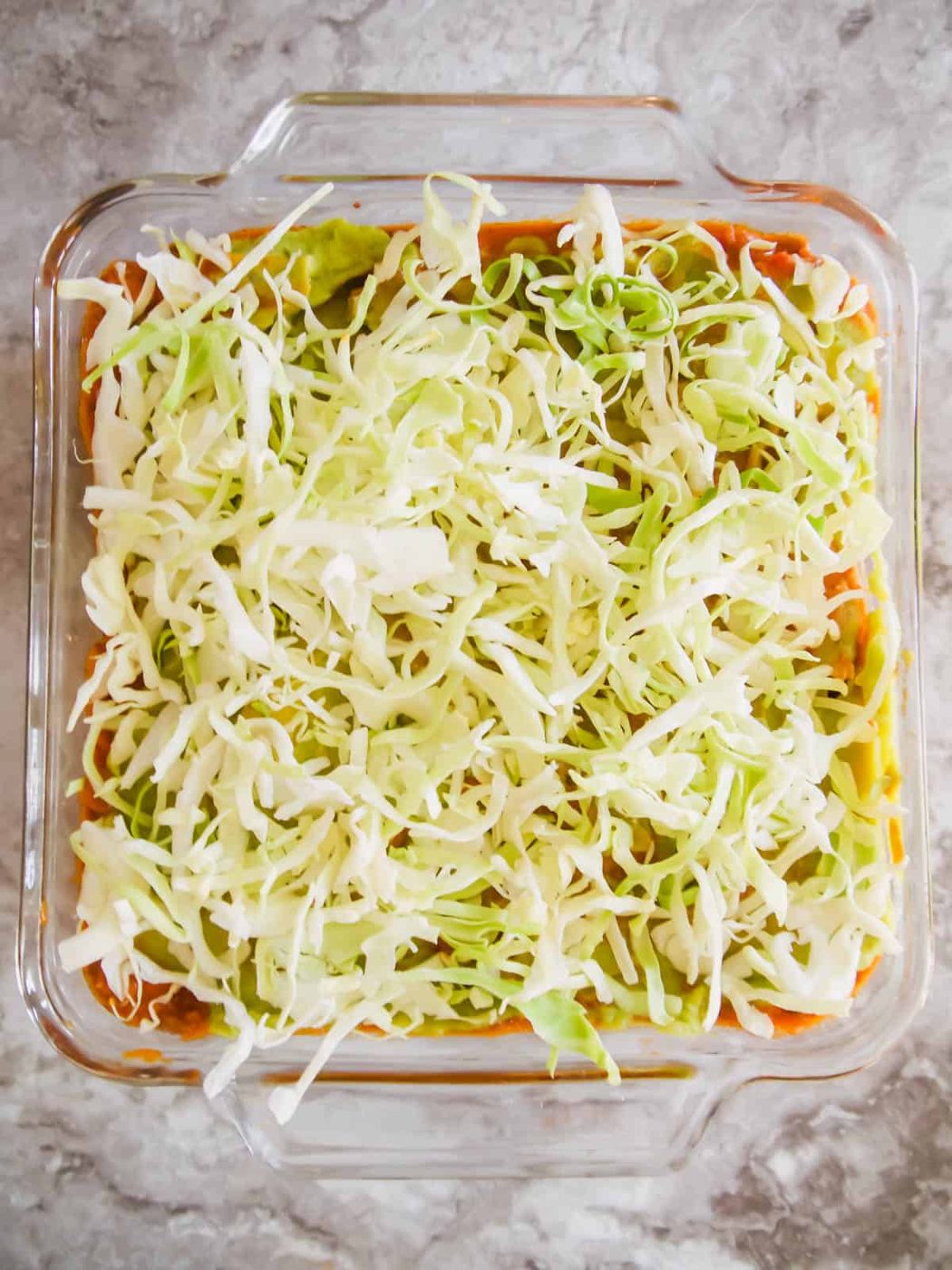 Lettuce layer added to the pan.
