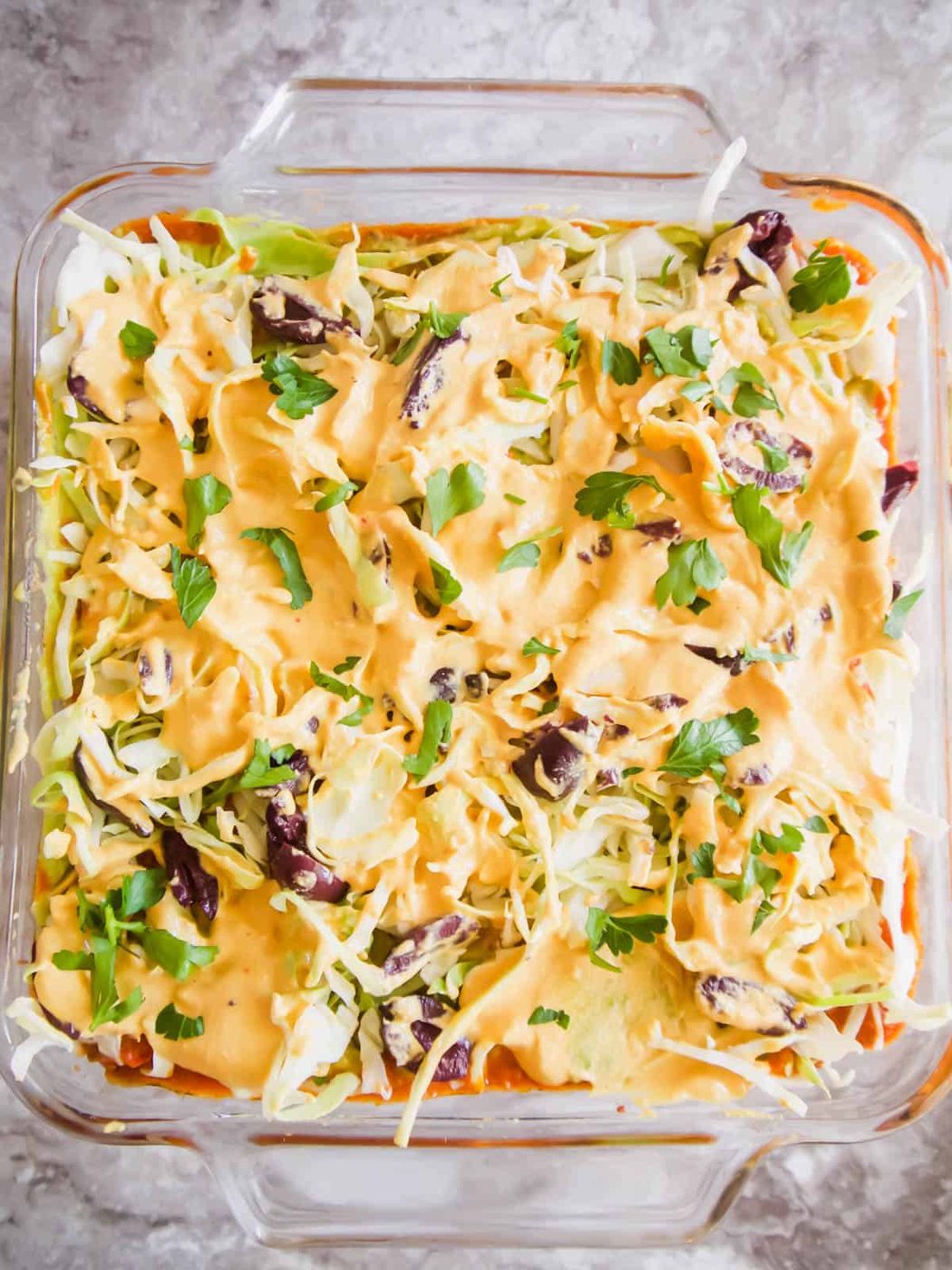Dairy free queso and olives added to the pan.