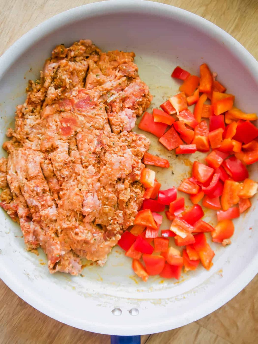 Ground turkey in a pan with added bell peppers.