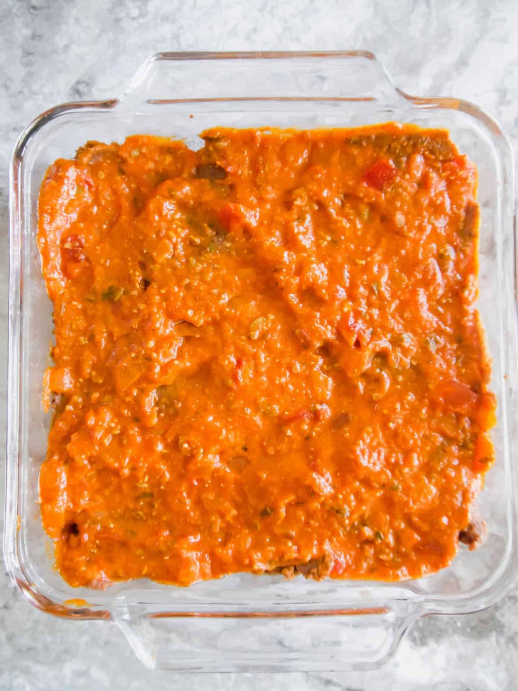 Salsa layer added to the pan.