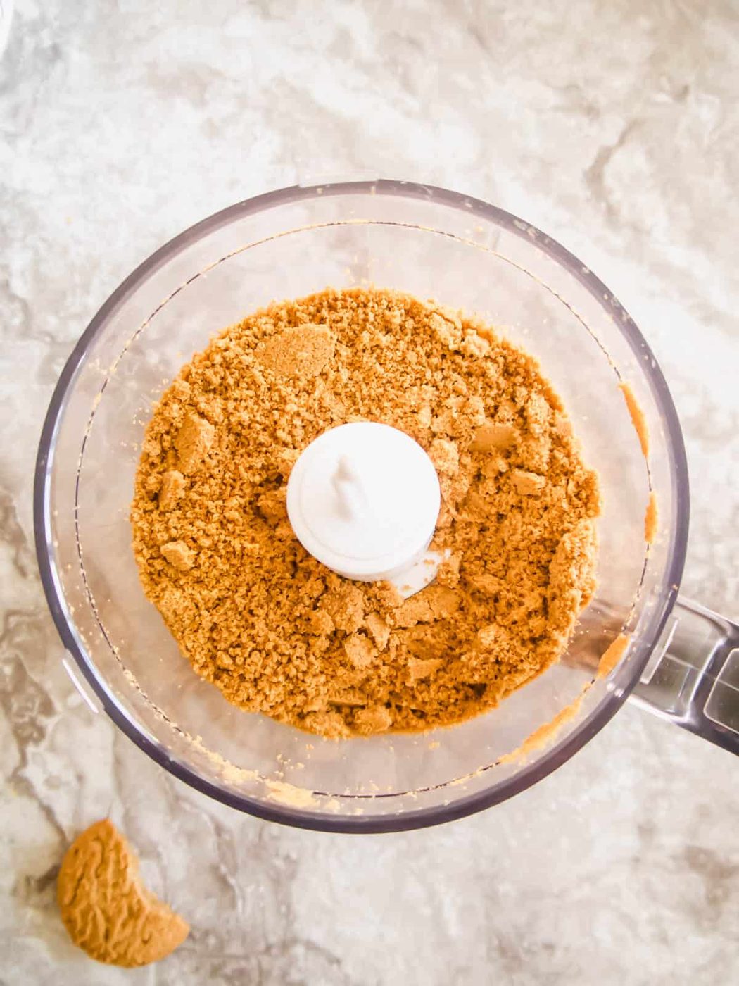 Crushed up cookies in a food processor.
