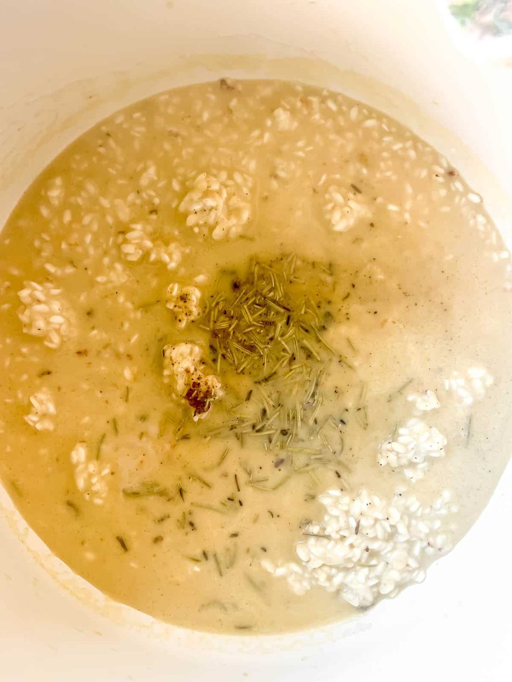 Chicken broth and spices added to the pan.