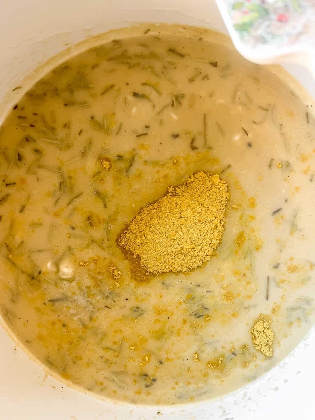 More broth and nutritional yeast added to the risotto while cooking.