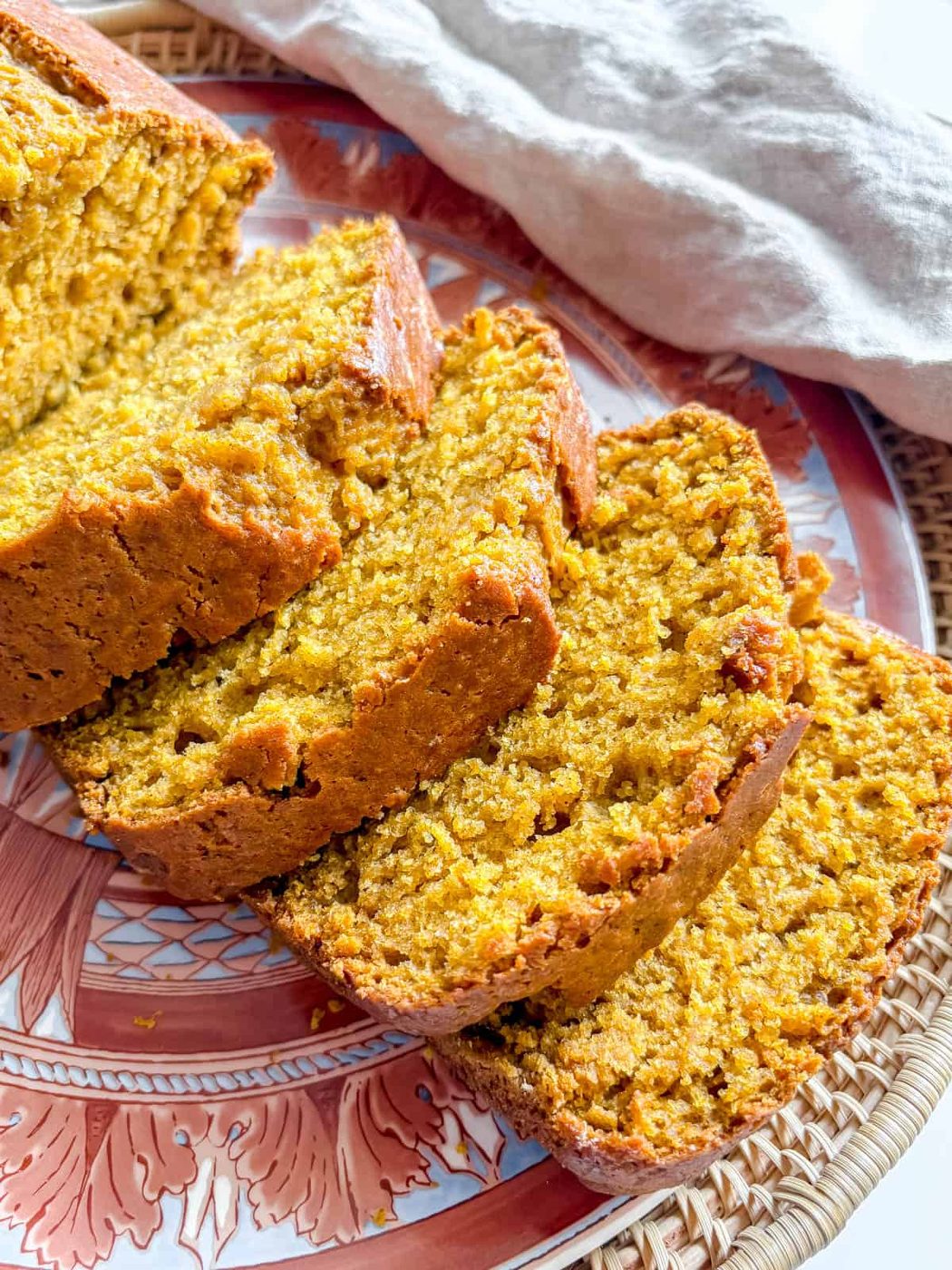 Slices of moist pumpkin bread on a plate.
